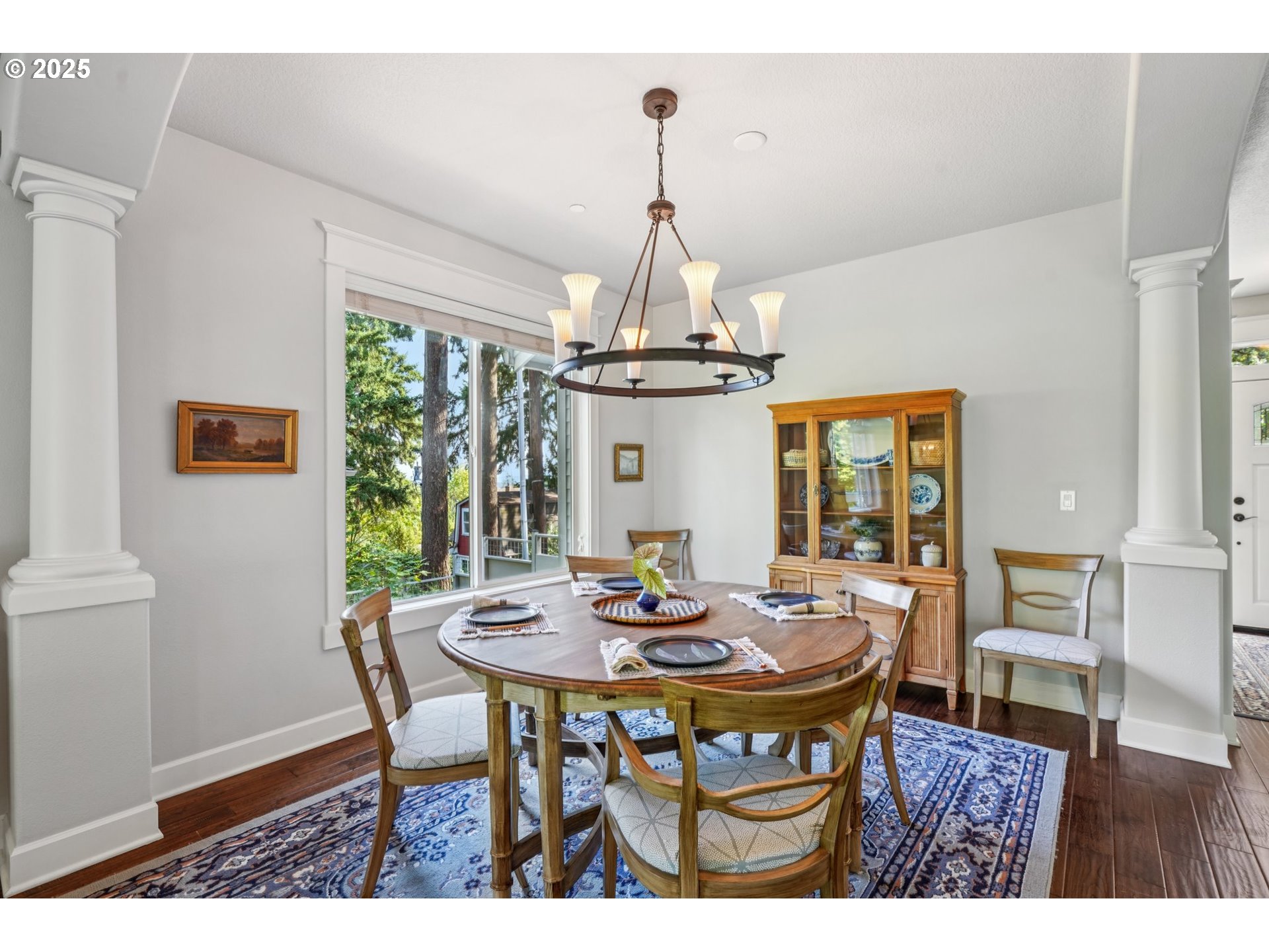 5862 Southwest Ralston Drive Portland, OR 97239 - Photo 8 of 41 a dining room with furniture a chandelier and wooden floor