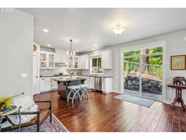 a kitchen with stainless steel appliances granite countertop a sink stove and cabinets