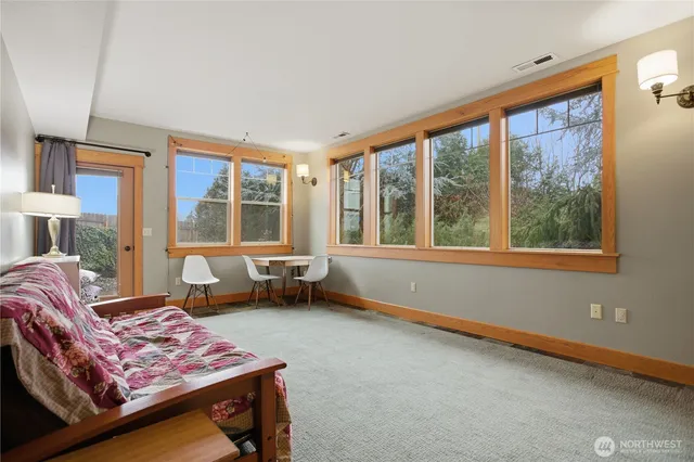 a bedroom with furniture and large windows
