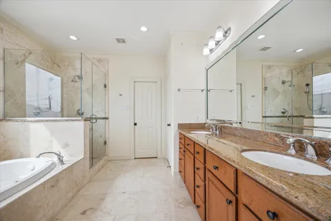 a bathroom with a tub a toilet and a shower