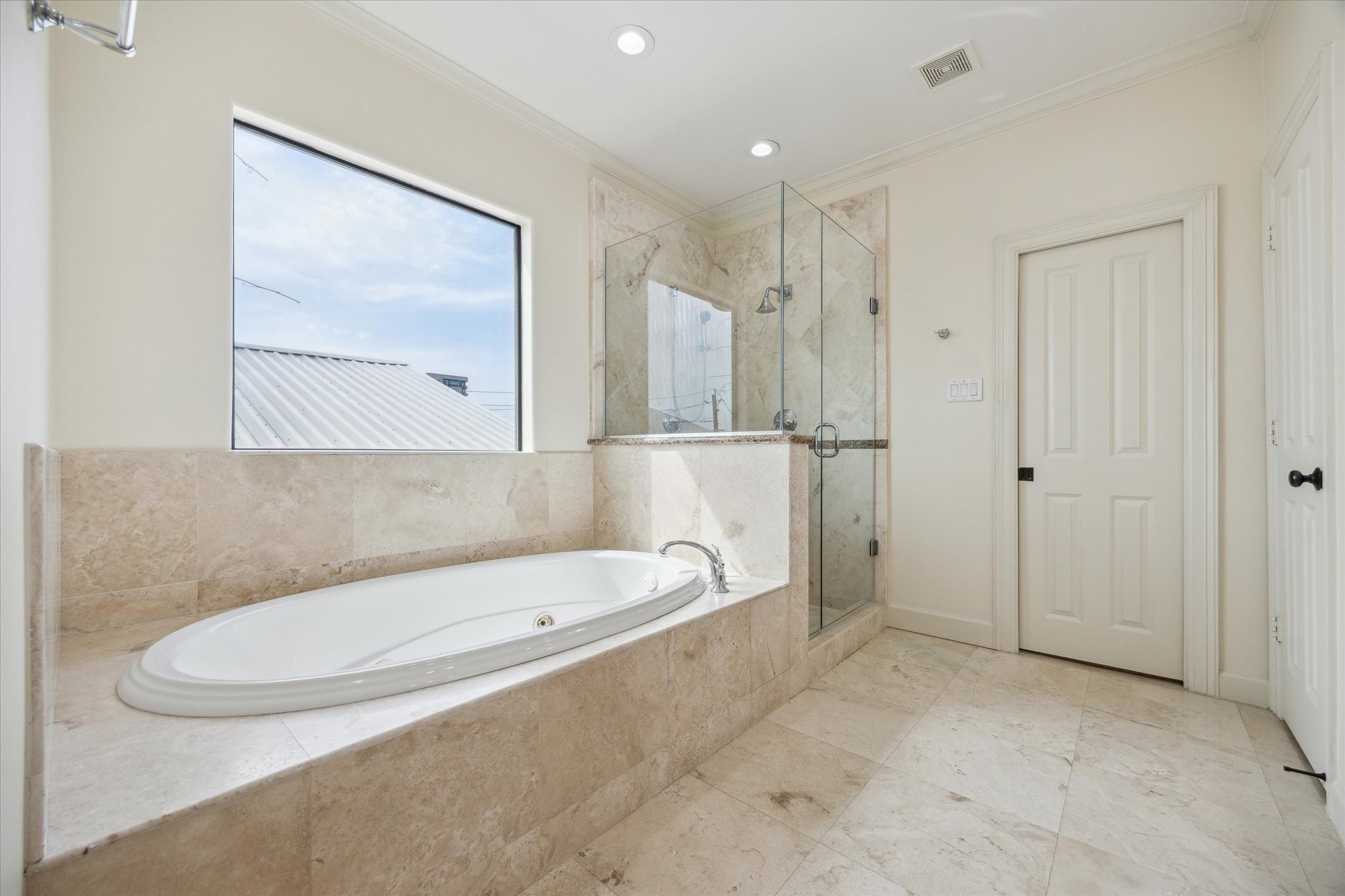 415 Tuam Street Houston, TX 77006 - Photo 15 of 21 a bathroom with a tub a toilet and a shower