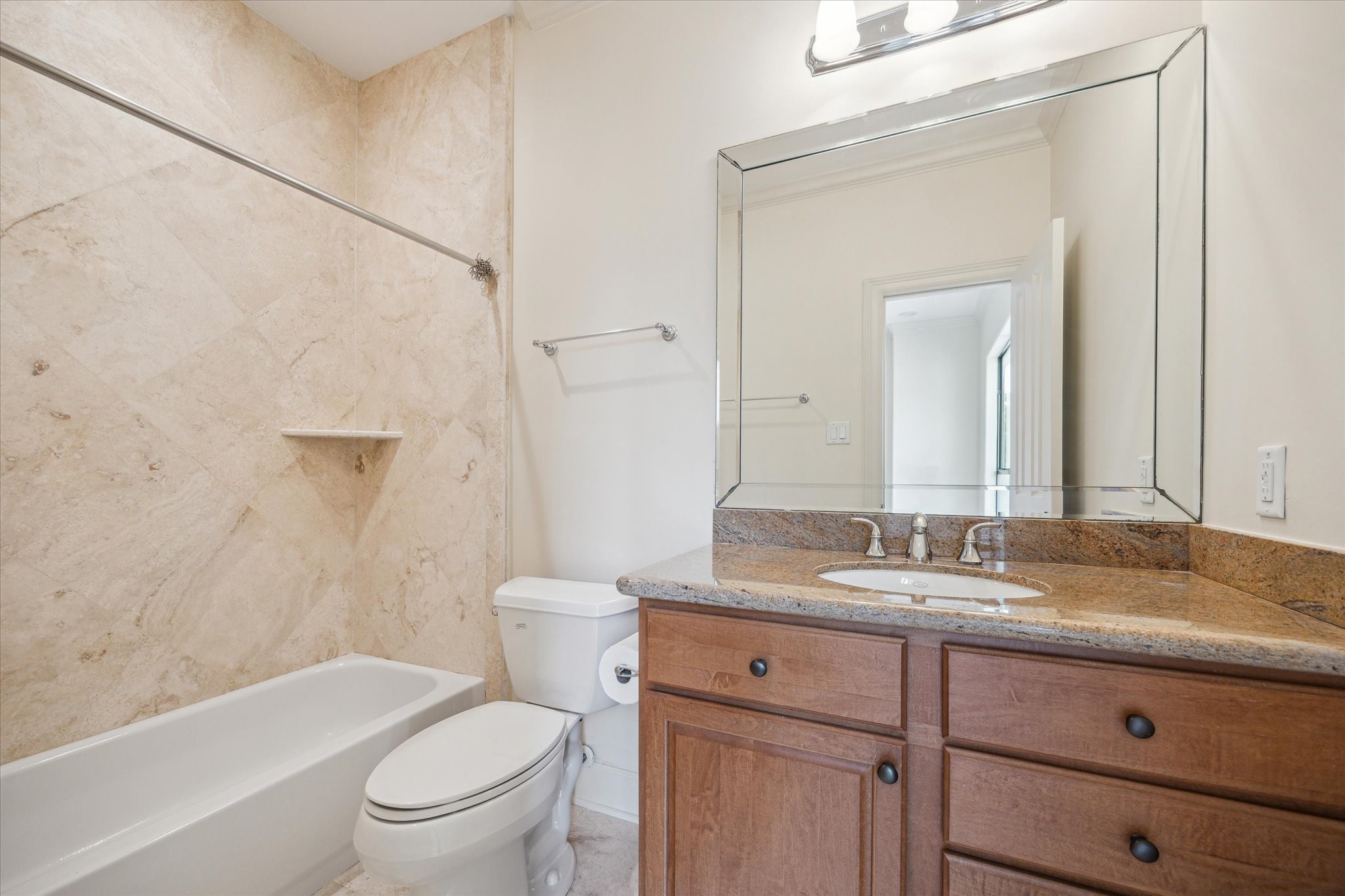 415 Tuam Street Houston, TX 77006 - Photo 18 of 21 a bathroom with a granite countertop toilet a sink and a mirror