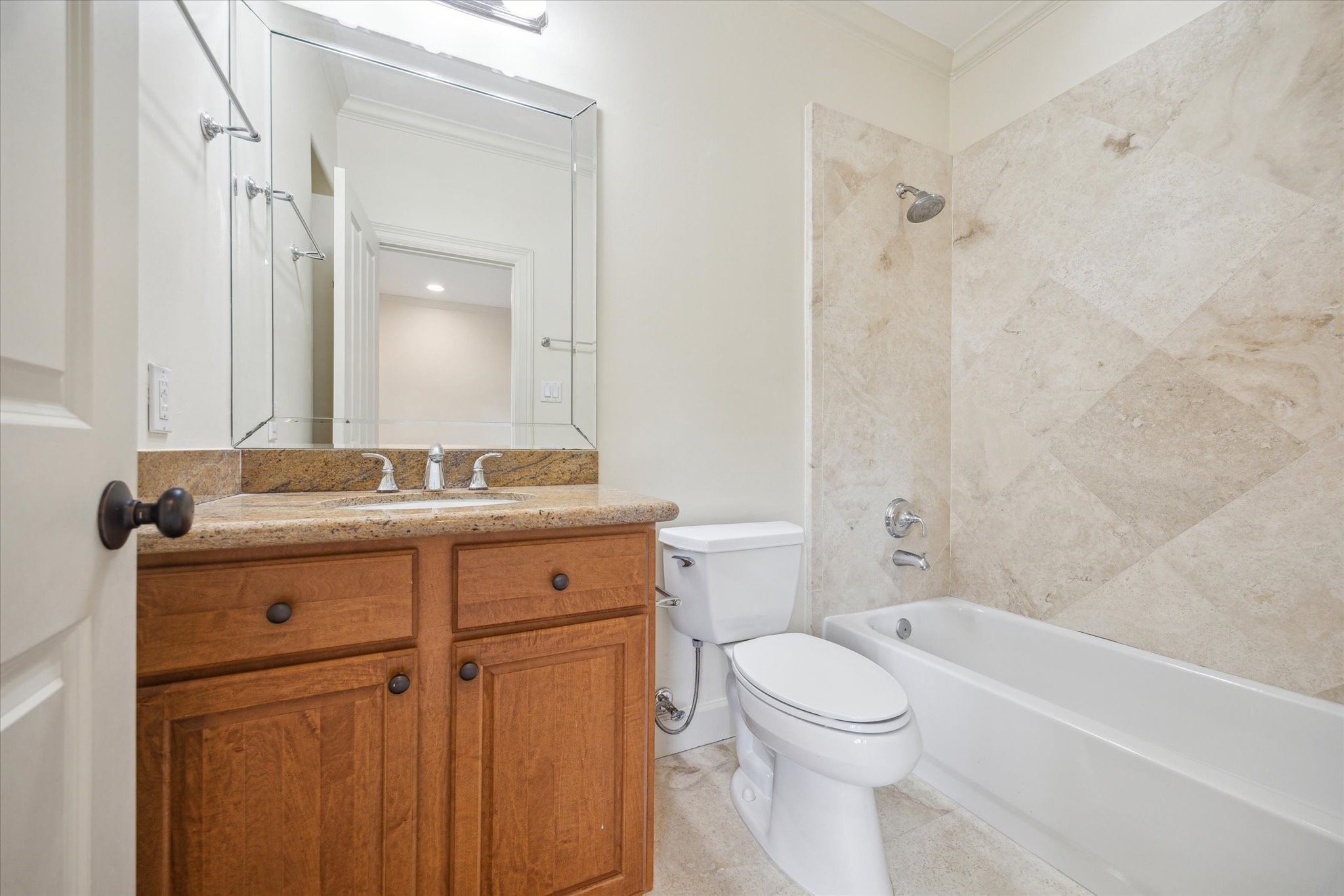 415 Tuam Street Houston, TX 77006 - Photo 21 of 21 a bathroom with a granite countertop toilet a sink and a bathtub