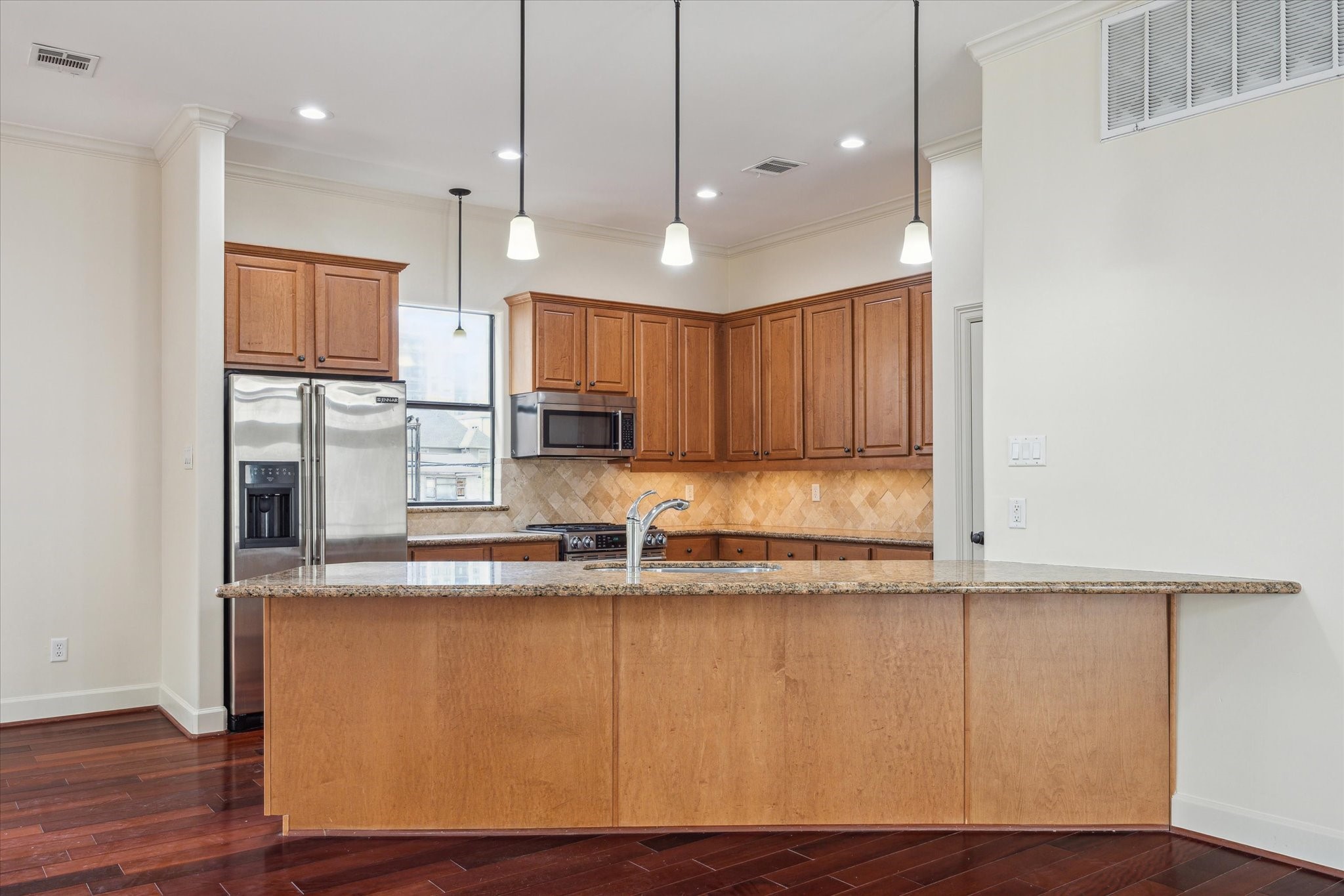 415 Tuam Street Houston, TX 77006 - Photo 6 of 21 a kitchen with kitchen island granite countertop wooden cabinets and a sink