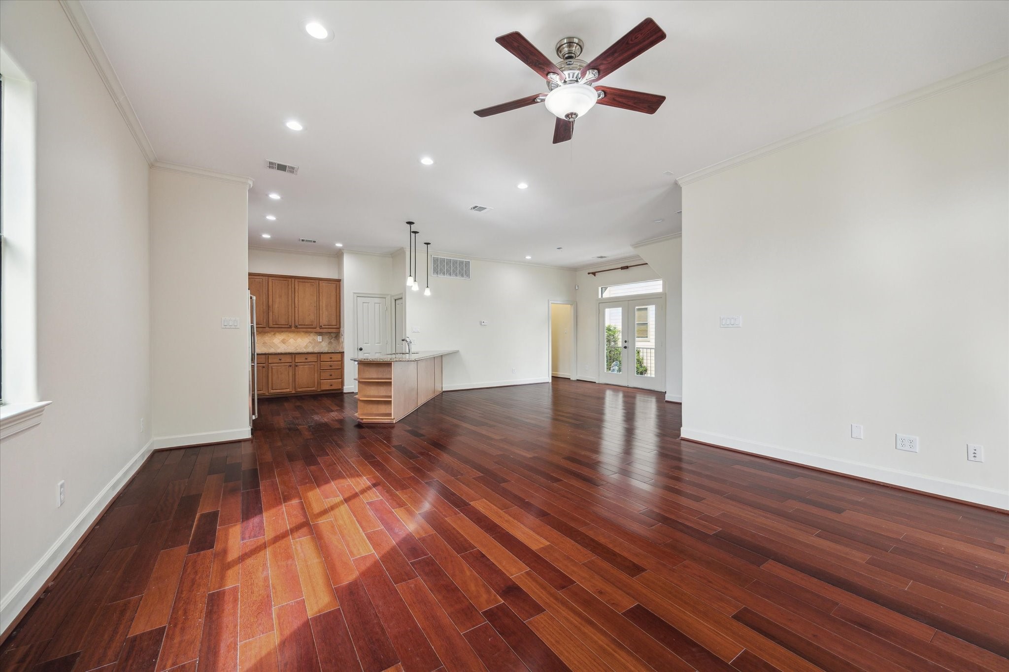 415 Tuam Street Houston, TX 77006 - Photo 10 of 21 a view of an empty room with wooden floor and a ceiling fan