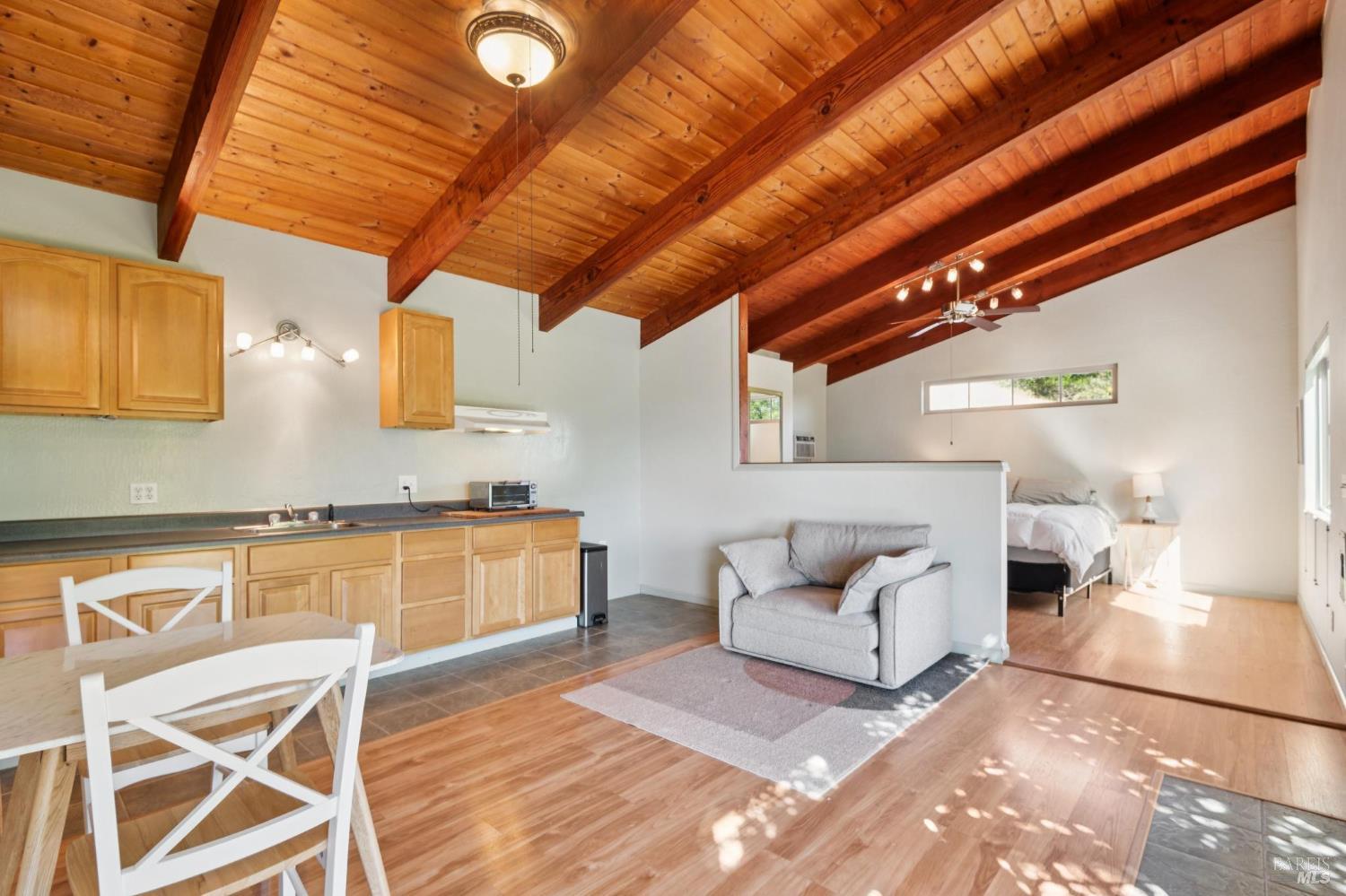 6960 Round Oak Road Penngrove, CA 94951 - Photo 47 of 58 a spacious bedroom with a bed a couch and chandelier