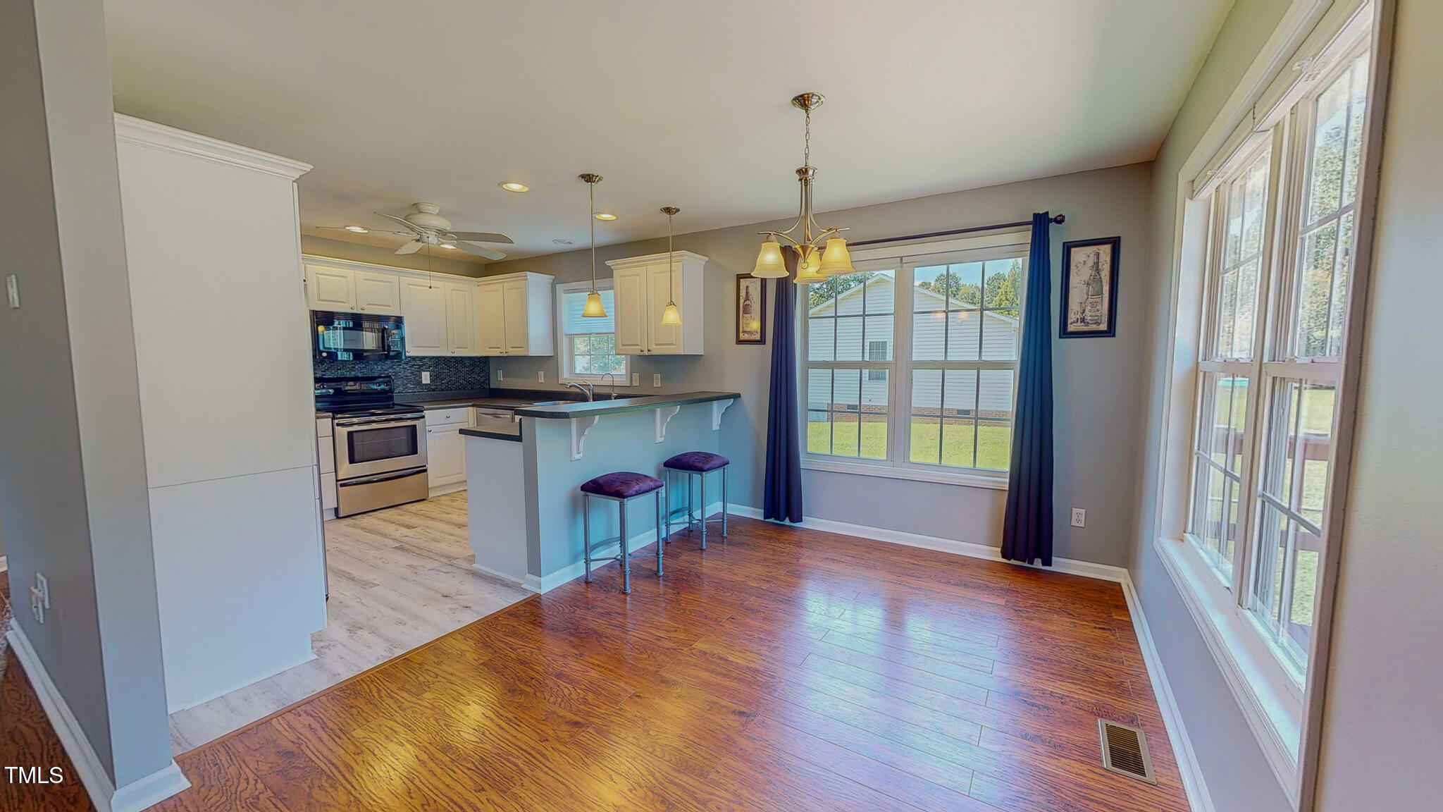 128 Punch Hill Farm Road Rougemont, NC 27572 - Photo 2 of 45 a open kitchen with stainless steel appliances granite countertop a refrigerator a stove top oven and a large window with wooden floor