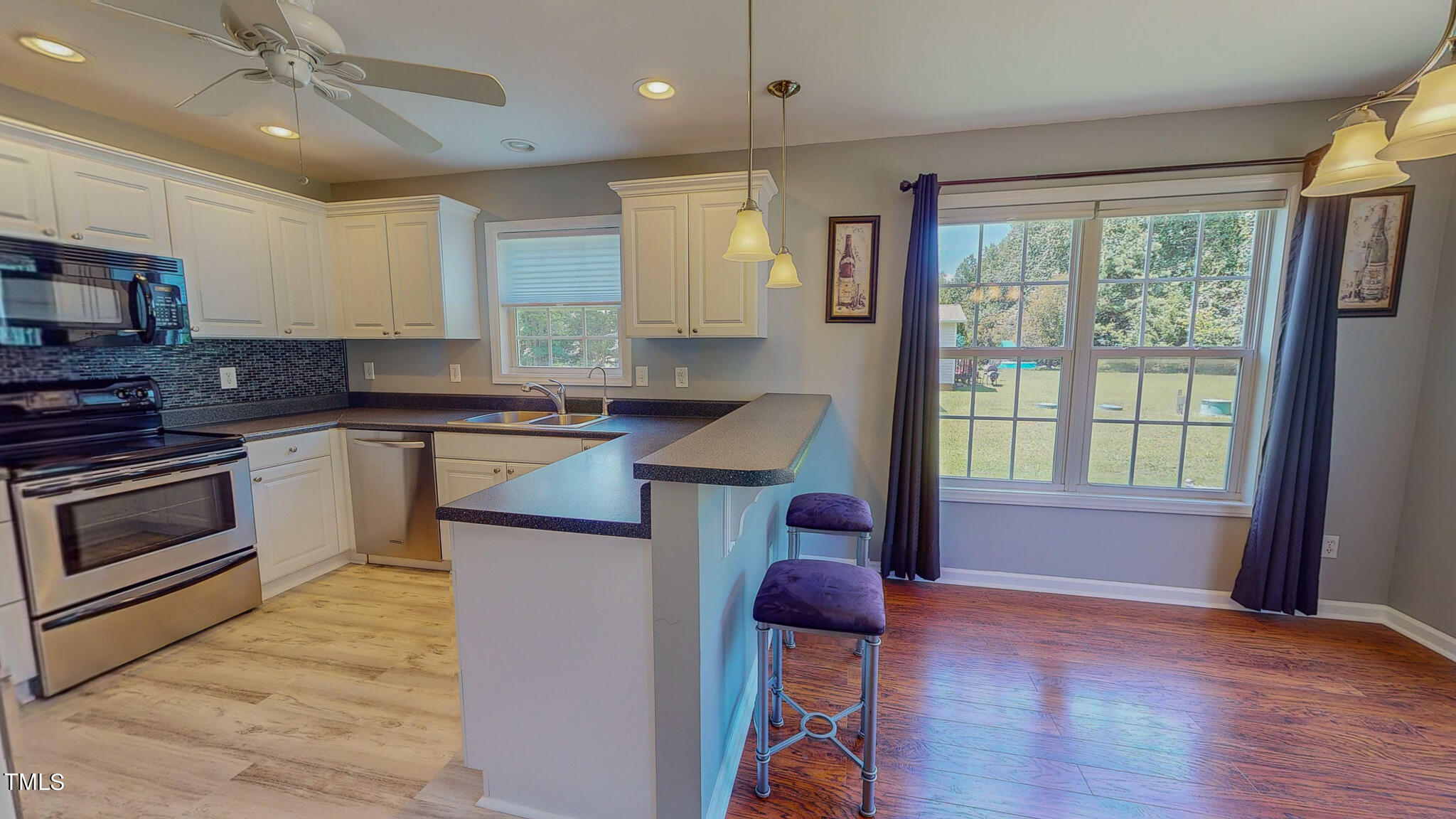 128 Punch Hill Farm Road Rougemont, NC 27572 - Photo 7 of 45 a kitchen with a stove a sink and a microwave