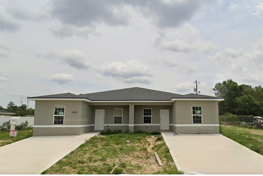 15885 Southwest 35th Court Road, Unit 2 Ocala, FL 34473 - Photo 1 of 4 front view of a house with a yard