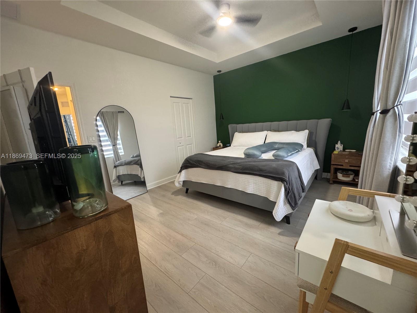 16270 Southwest 293rd Street Homestead, FL 33033 - Photo 11 of 13 a bedroom with a bed a flat screen tv and dresser