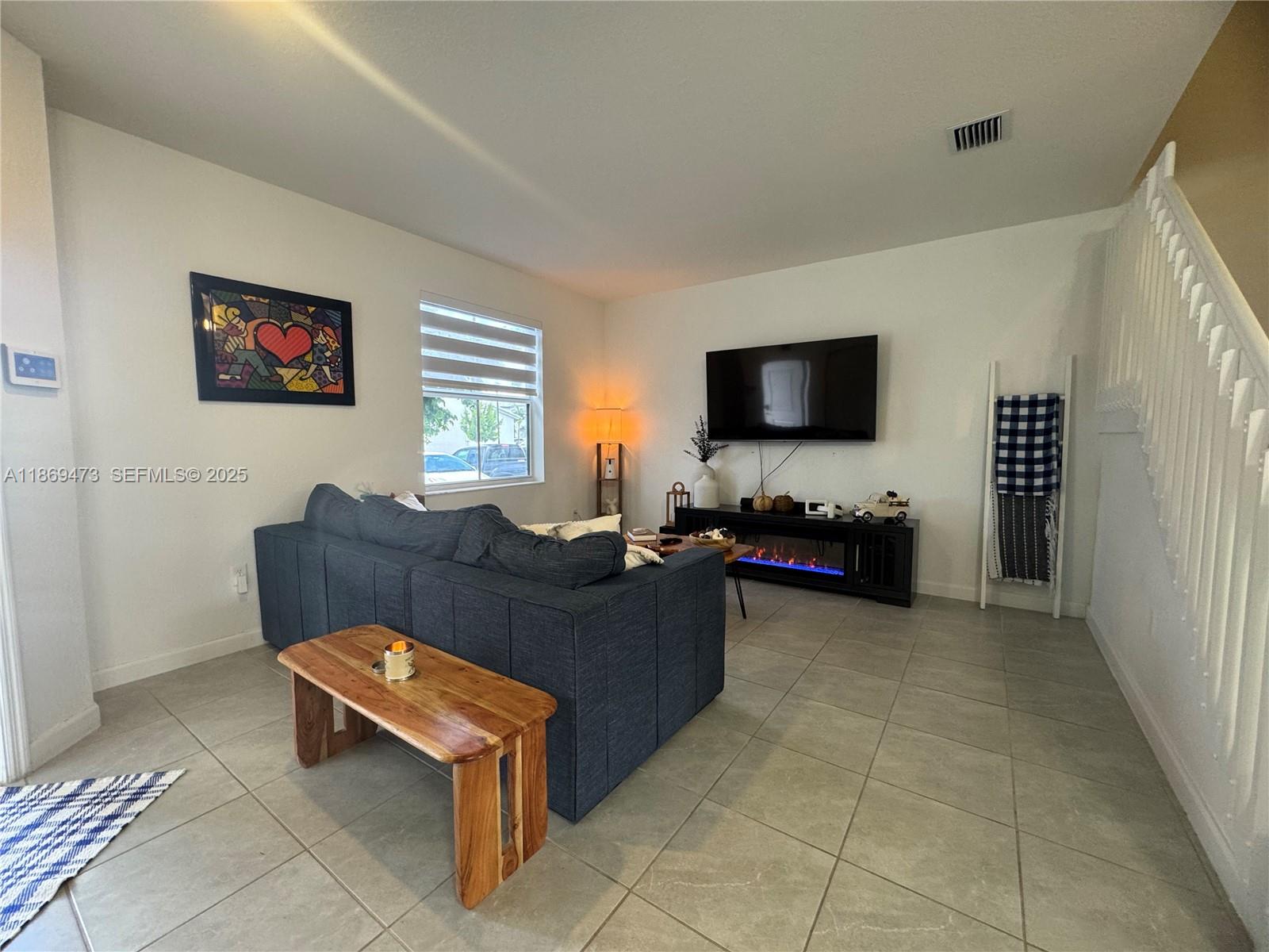 16270 Southwest 293rd Street Homestead, FL 33033 - Photo 4 of 13 a living room with furniture and a flat screen tv