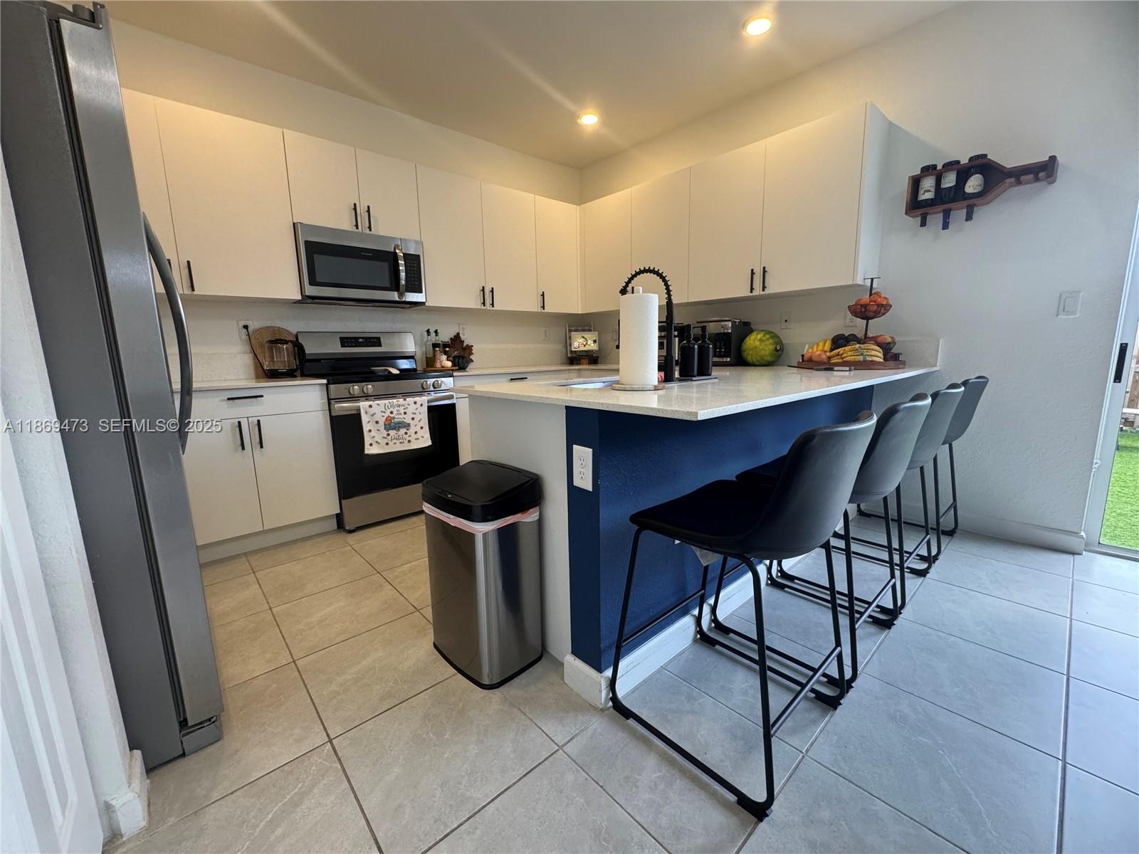 16270 Southwest 293rd Street Homestead, FL 33033 - Photo 6 of 13 a kitchen with a sink appliances and cabinets