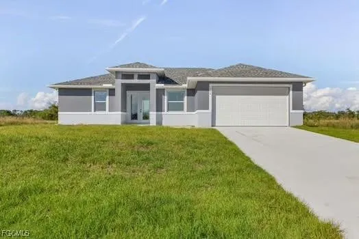 a front view of a house with a garden and yard