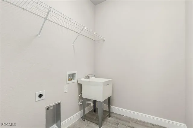 a bathroom with a sink a light fixture and a toilet