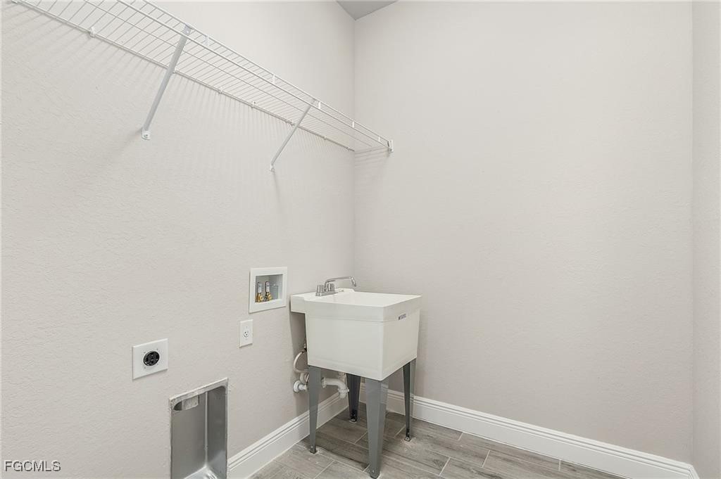910 Emerald Street LaBelle, FL 33935 - Photo 17 of 19 a bathroom with a sink a light fixture and a toilet