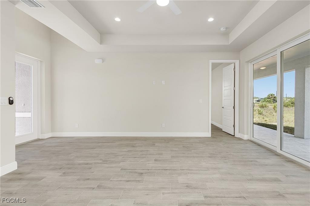 910 Emerald Street LaBelle, FL 33935 - Photo 5 of 19 wooden floor in an empty room with a window