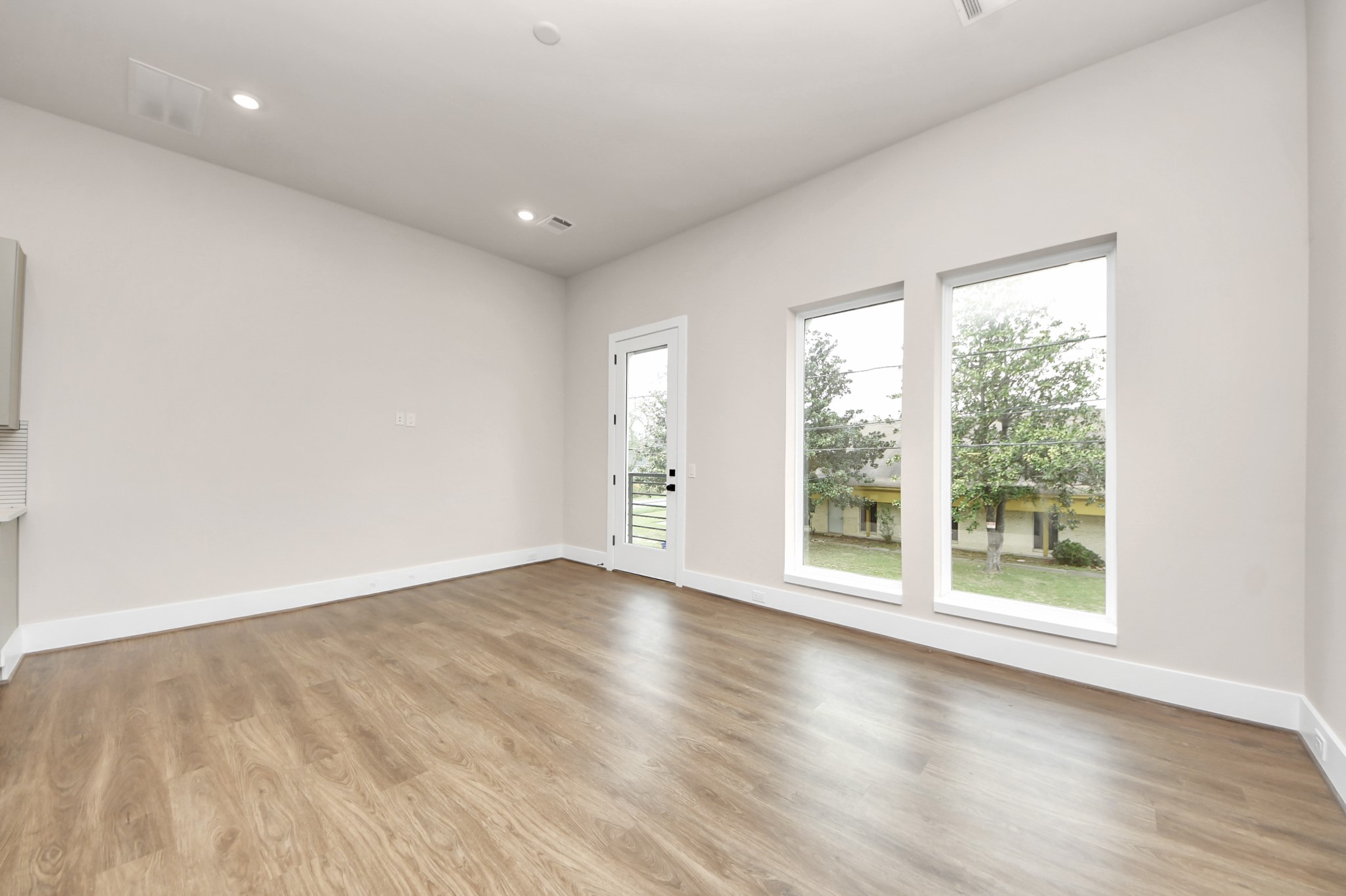 783 Mansfield Street Houston, TX 77091 - Photo 11 of 40 an empty room with wooden floor and windows