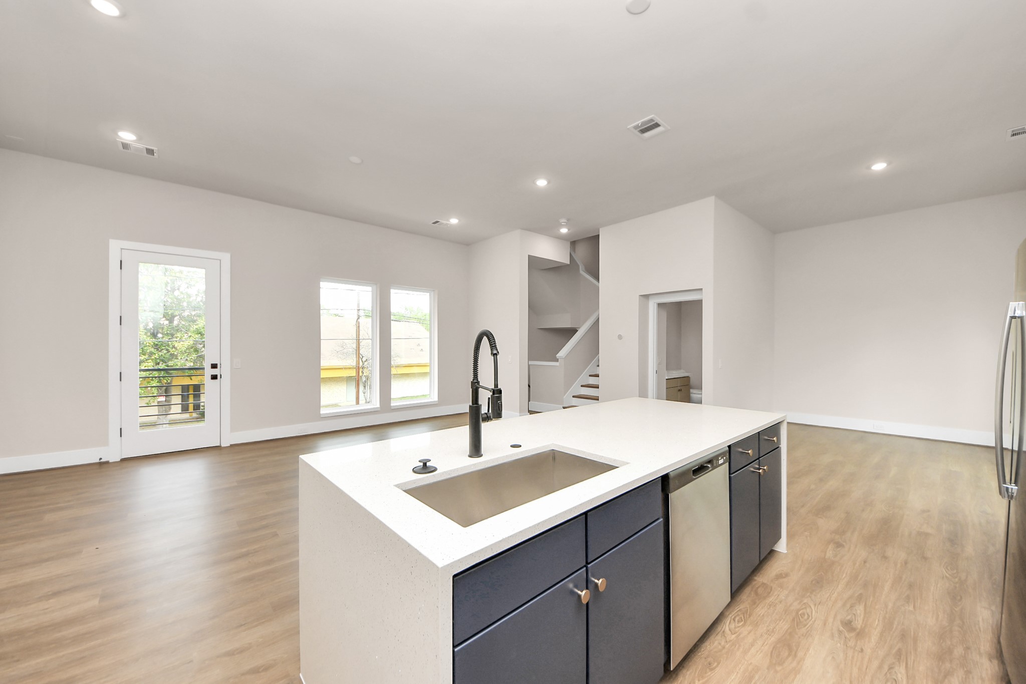 783 Mansfield Street Houston, TX 77091 - Photo 14 of 40 a view of a kitchen counter top a sink and dishwasher with wooden floor
