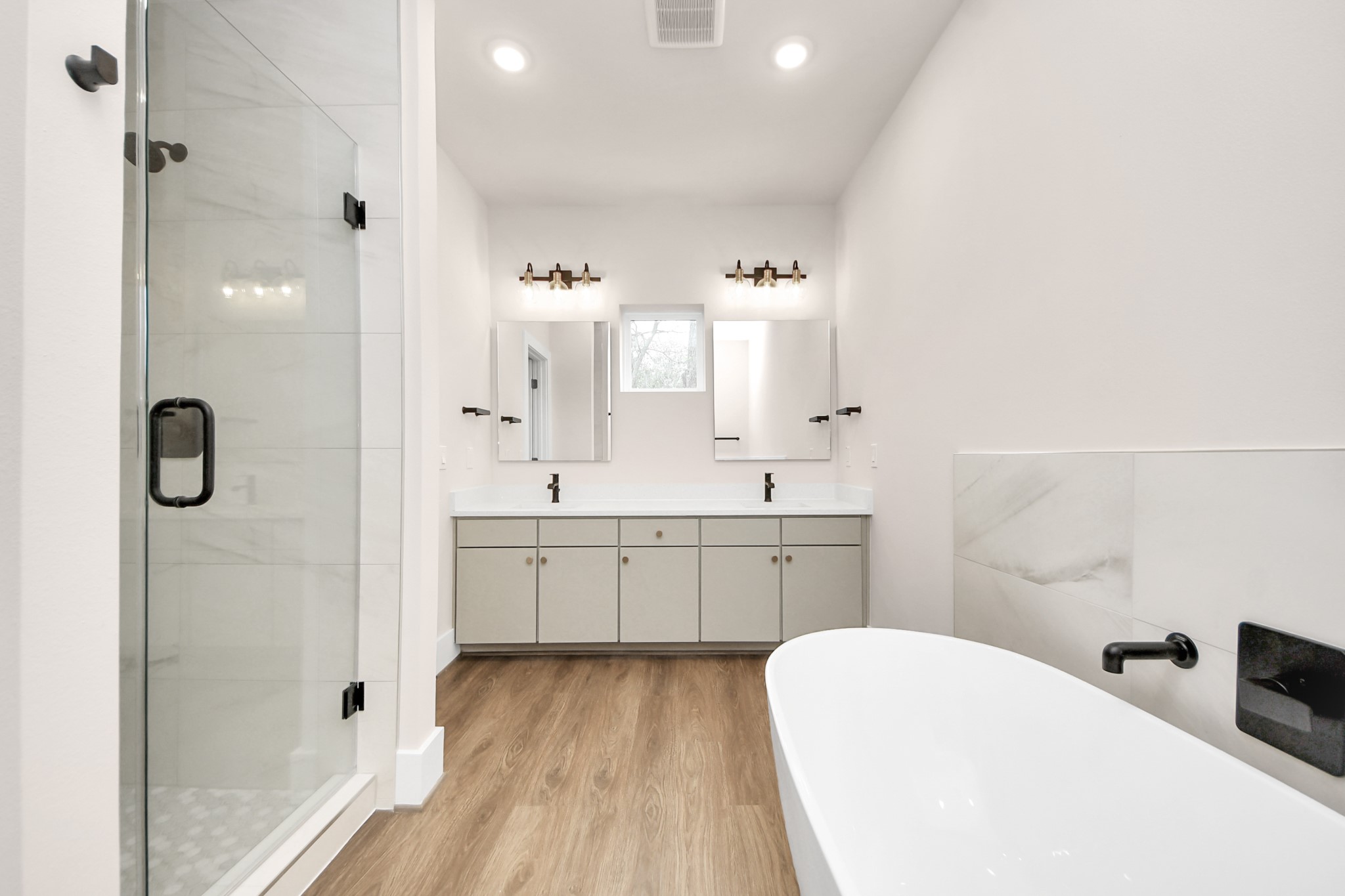 783 Mansfield Street Houston, TX 77091 - Photo 34 of 40 a spacious bathroom with a double vanity sink mirror and shower