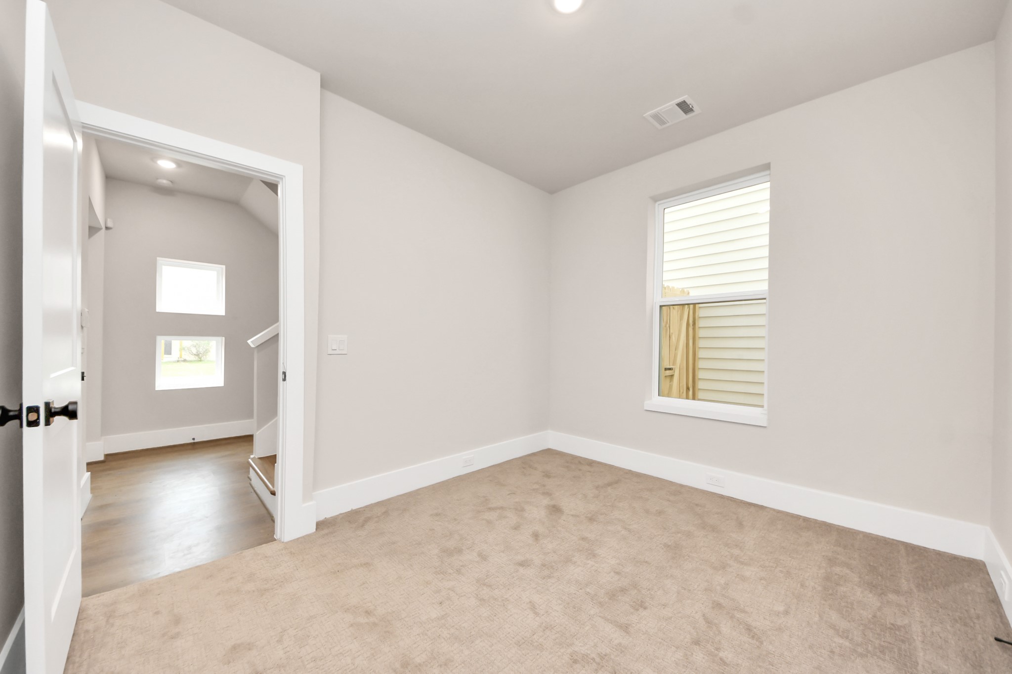 783 Mansfield Street Houston, TX 77091 - Photo 6 of 40 an empty room with windows and entrance