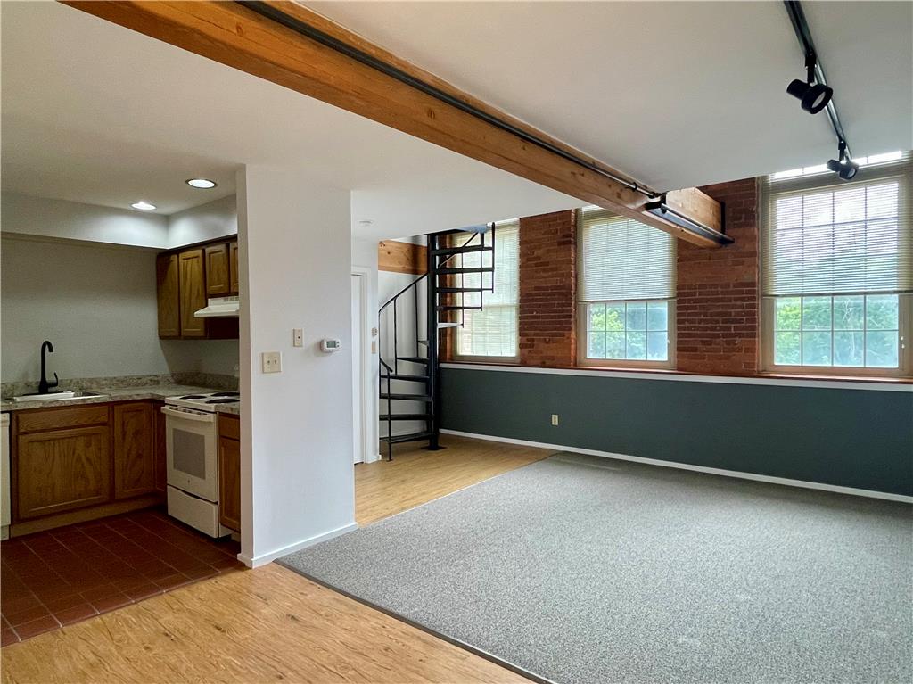 101 Race Street, Unit 205 Catasauqua, PA 18032 - Photo 2 of 19 Exposed brick walls and an open layout create an inviting industrial-chic living space.
