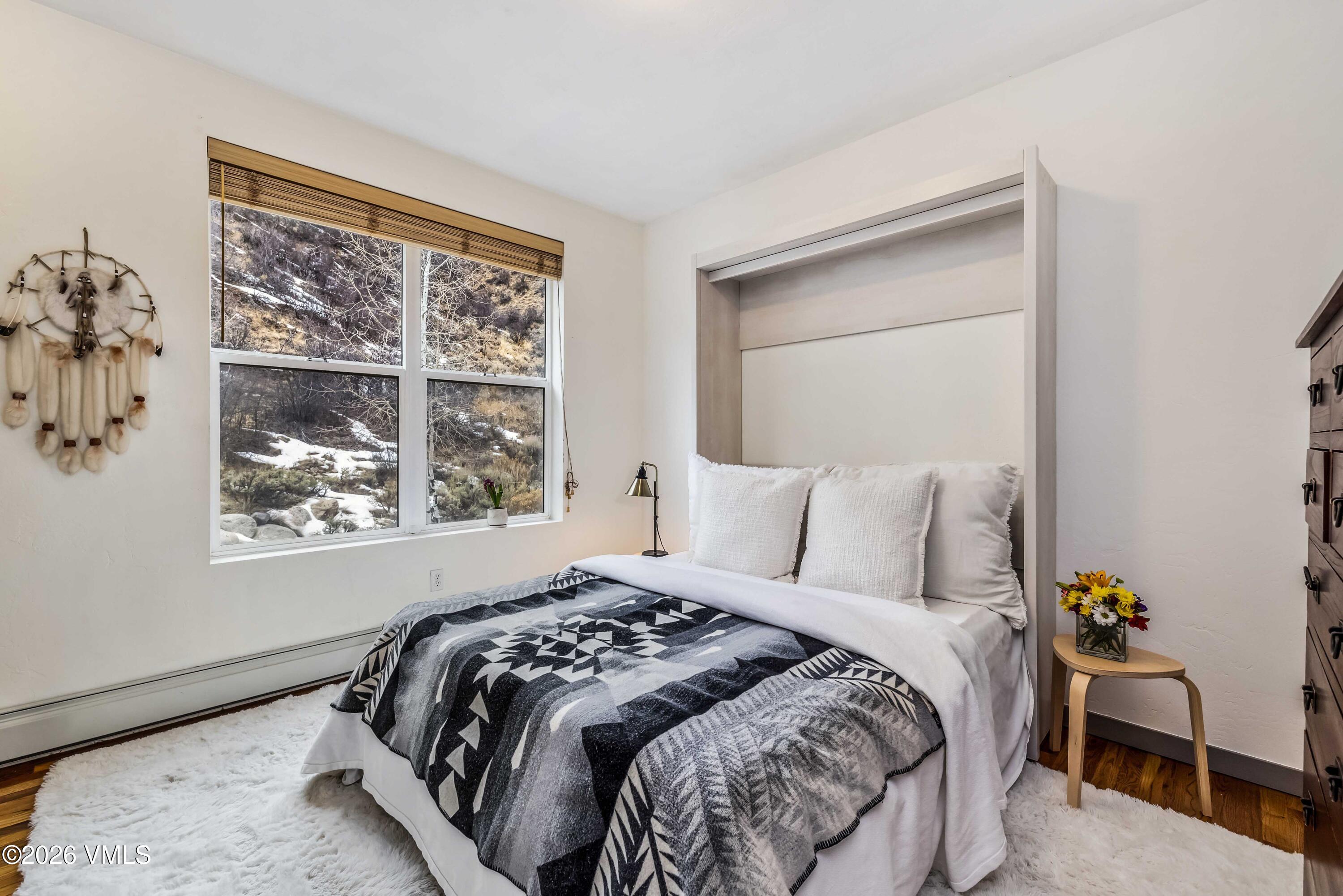 491 Metcalf Road, Unit A2 Avon, CO 81620 - Photo 15 of 23 a bed sitting in a bedroom next to a window