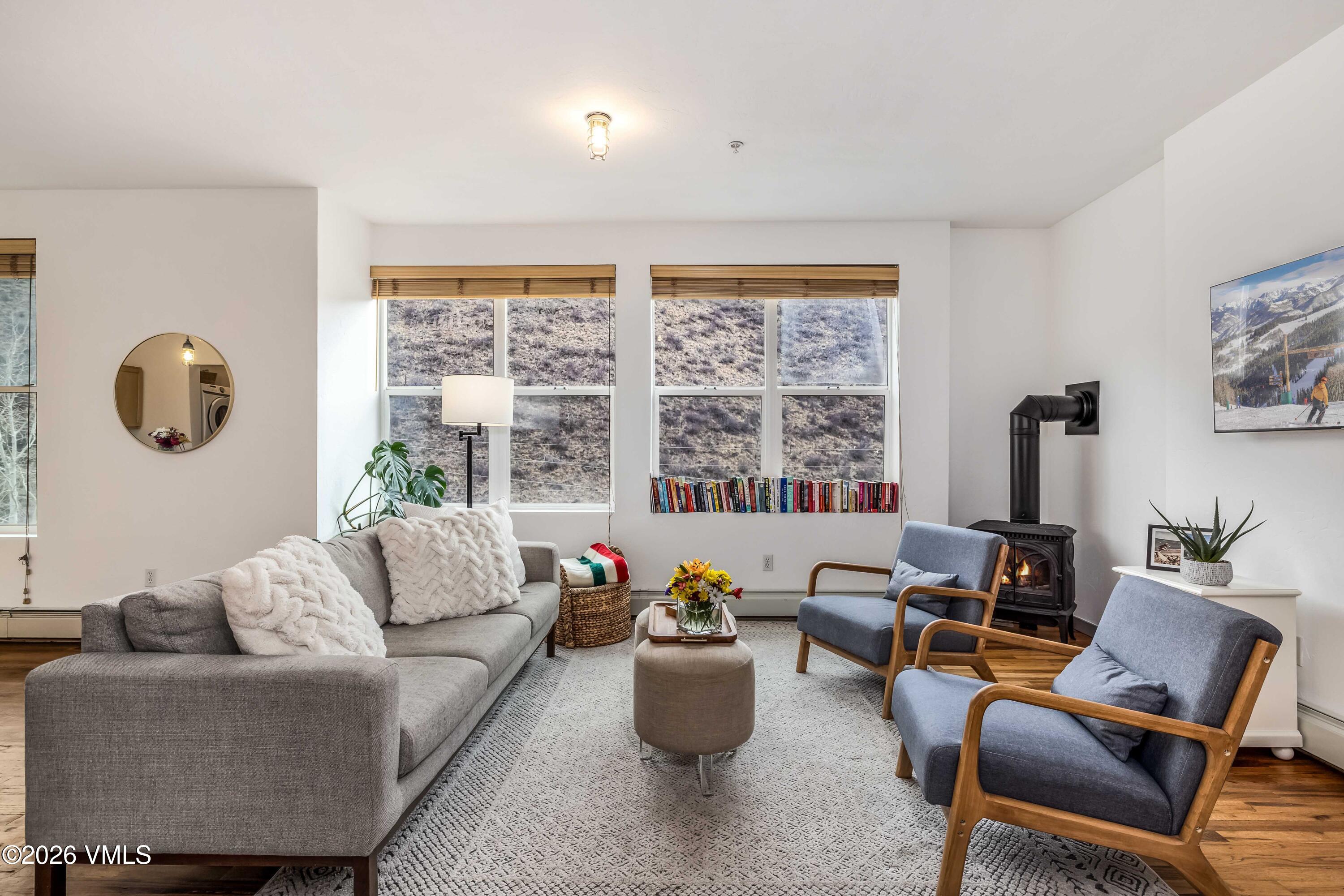 491 Metcalf Road, Unit A2 Avon, CO 81620 - Photo 2 of 23 a living room with furniture and floor to ceiling windows