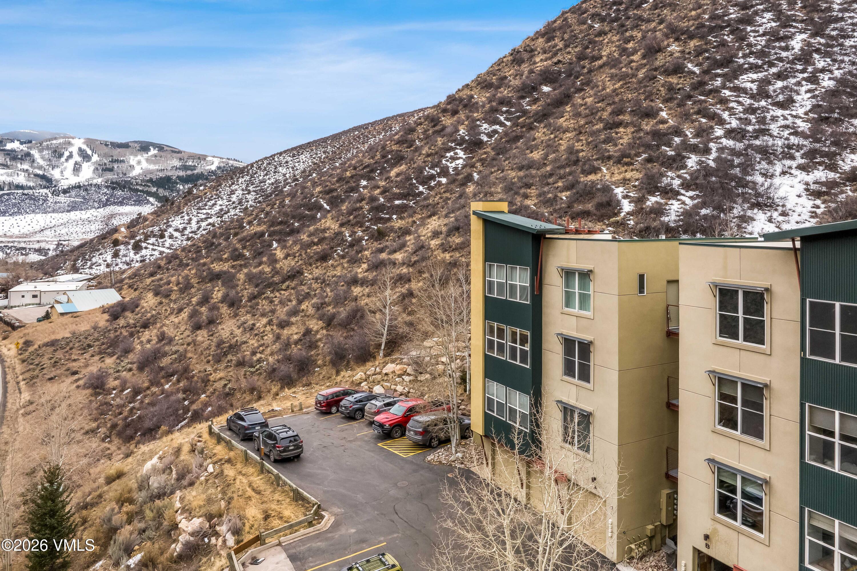 491 Metcalf Road, Unit A2 Avon, CO 81620 - Photo 21 of 23 a view of a blue house with yard and sitting area