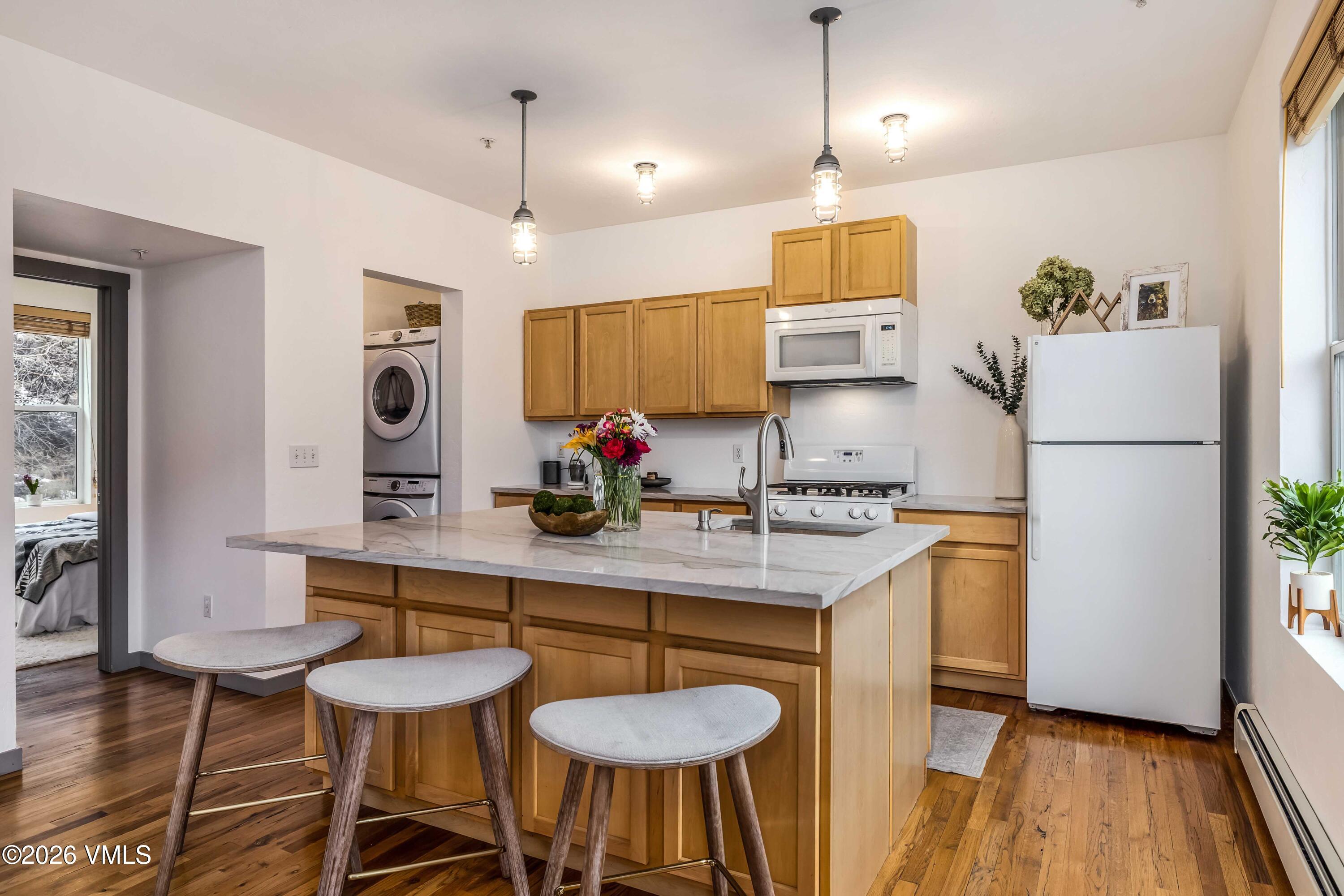 491 Metcalf Road, Unit A2 Avon, CO 81620 - Photo 7 of 23 a kitchen with stainless steel appliances granite countertop a sink a refrigerator and a stove