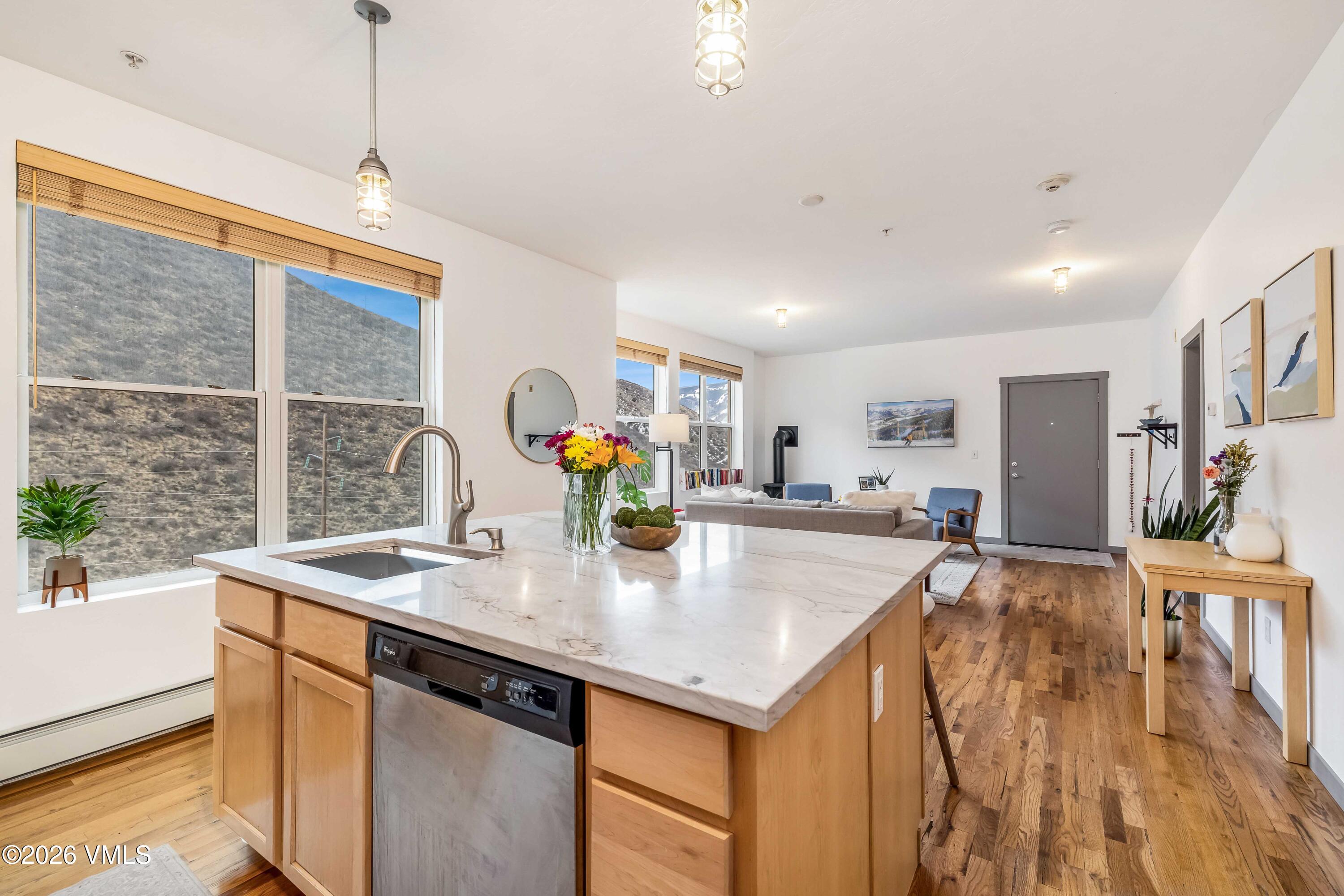 491 Metcalf Road, Unit A2 Avon, CO 81620 - Photo 8 of 23 a kitchen with a sink a counter top space and living room view