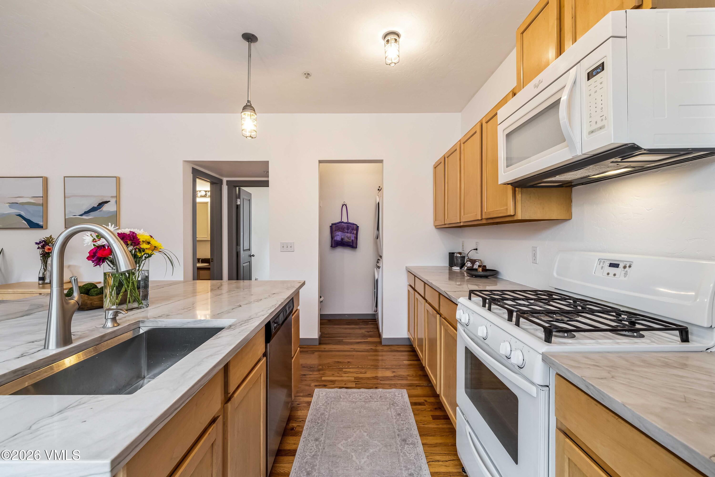 491 Metcalf Road, Unit A2 Avon, CO 81620 - Photo 9 of 23 a kitchen with stainless steel appliances granite countertop a sink stove and refrigerator
