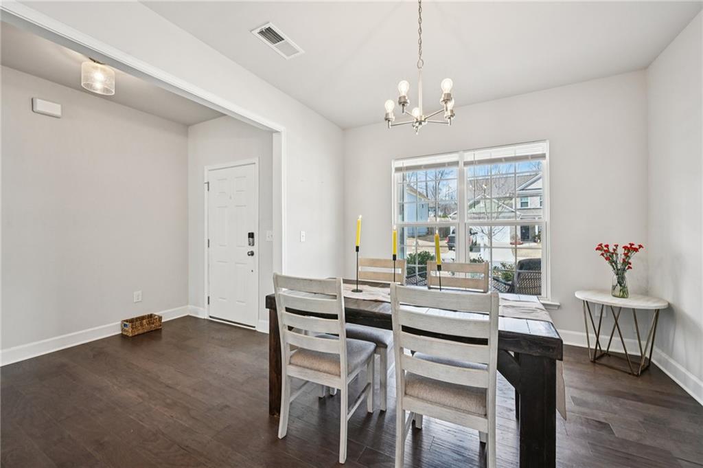 1283 Maston Road Auburn, GA 30011 - Photo 16 of 82 a view of a dining room with furniture wooden floor and chandelier