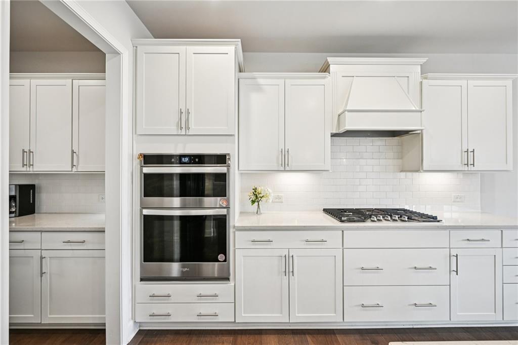 1283 Maston Road Auburn, GA 30011 - Photo 20 of 82 a kitchen with white cabinets and appliances