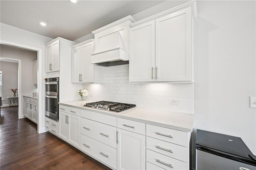 1283 Maston Road Auburn, GA 30011 - Photo 22 of 82 a kitchen with white cabinets and appliances