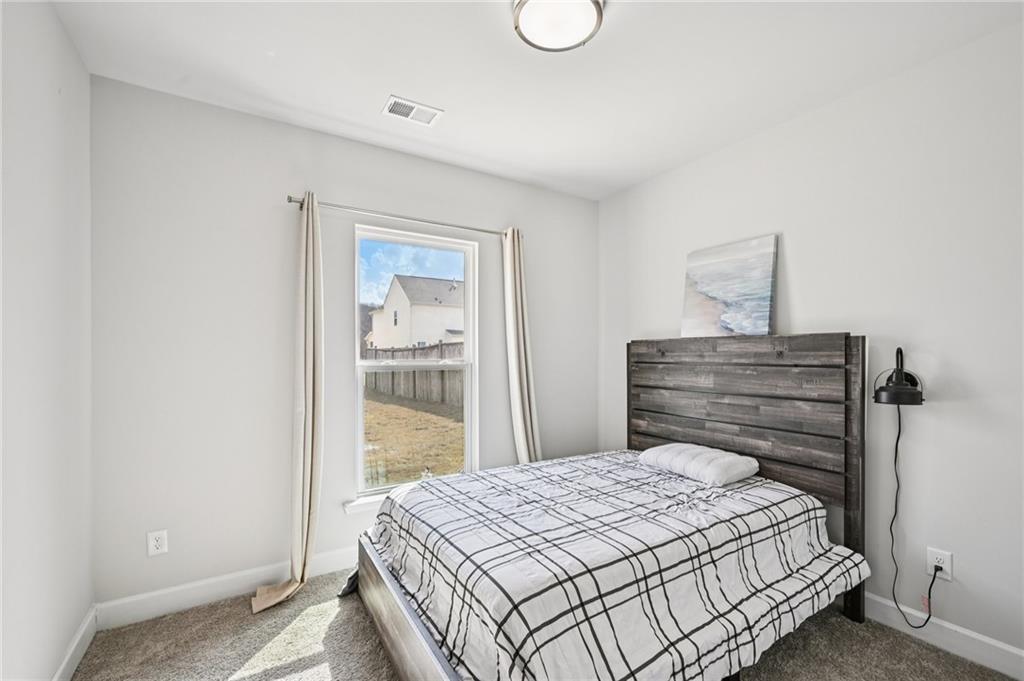 1283 Maston Road Auburn, GA 30011 - Photo 26 of 82 a bedroom with a bed and a window