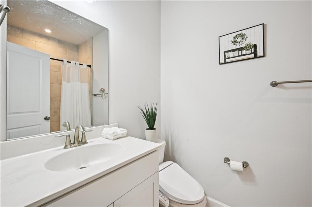 1283 Maston Road Auburn, GA 30011 - Photo 28 of 82 a bathroom with a sink mirror vanity and toilet