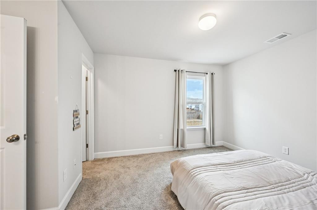 1283 Maston Road Auburn, GA 30011 - Photo 41 of 82 a bedroom with a bed and a window