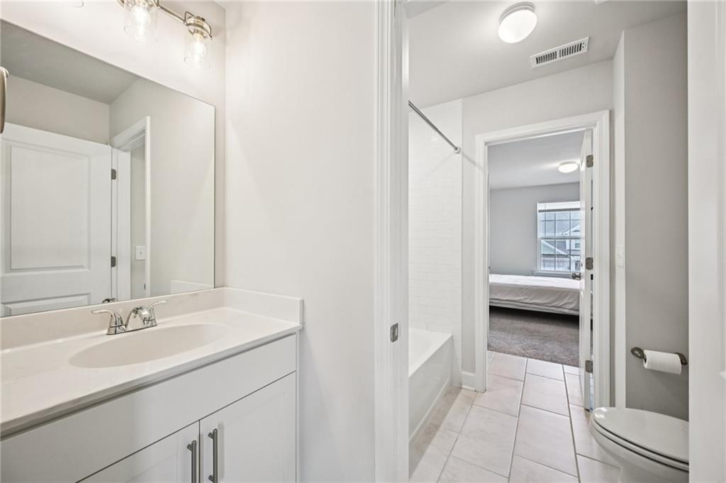 1283 Maston Road Auburn, GA 30011 - Photo 45 of 82 a en suite bathroom with a sink a mirror and a shower