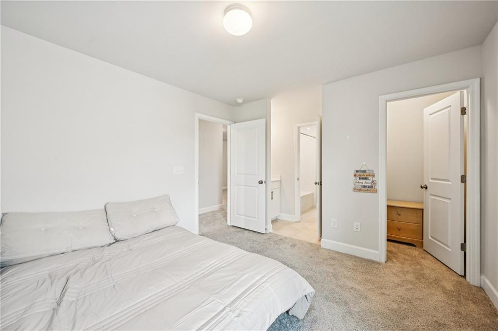 1283 Maston Road Auburn, GA 30011 - Photo 47 of 82 a spacious bedroom with a bed and a shower