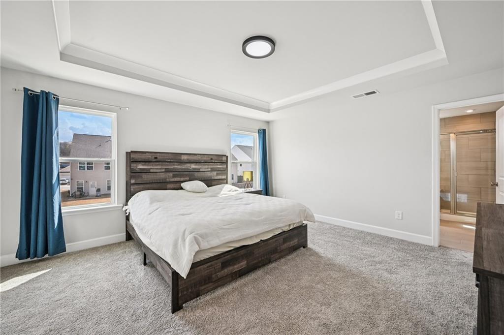 1283 Maston Road Auburn, GA 30011 - Photo 49 of 82 a spacious bedroom with a bed and a dresser