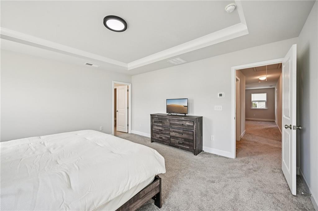 1283 Maston Road Auburn, GA 30011 - Photo 51 of 82 a bedroom with a bed and dresser