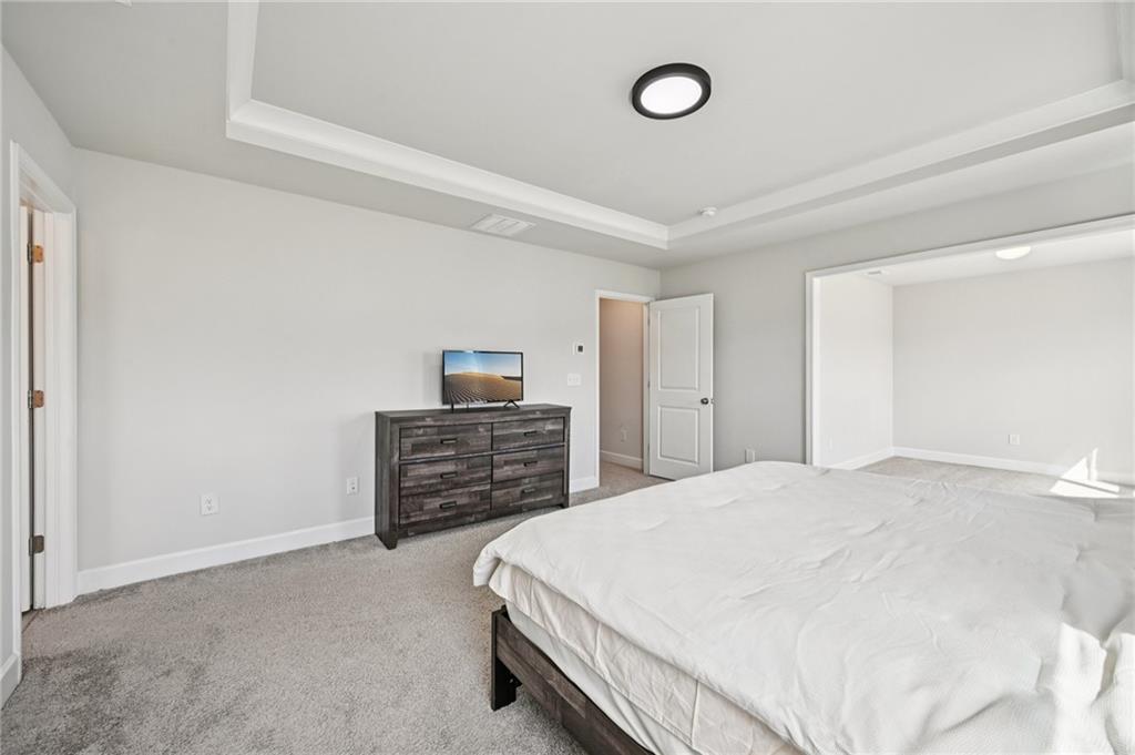 1283 Maston Road Auburn, GA 30011 - Photo 52 of 82 a bedroom with a bed and a flat screen tv