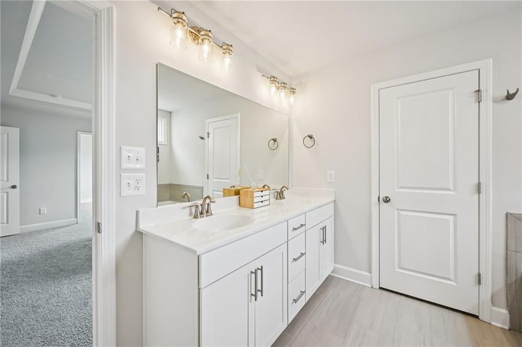 1283 Maston Road Auburn, GA 30011 - Photo 54 of 82 a bathroom with a sink a mirror and a vanity