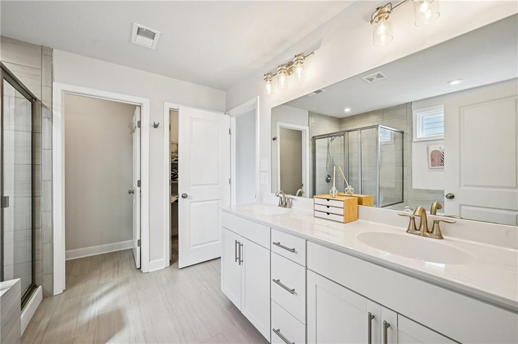 1283 Maston Road Auburn, GA 30011 - Photo 57 of 82 a bathroom with a sink and a mirror