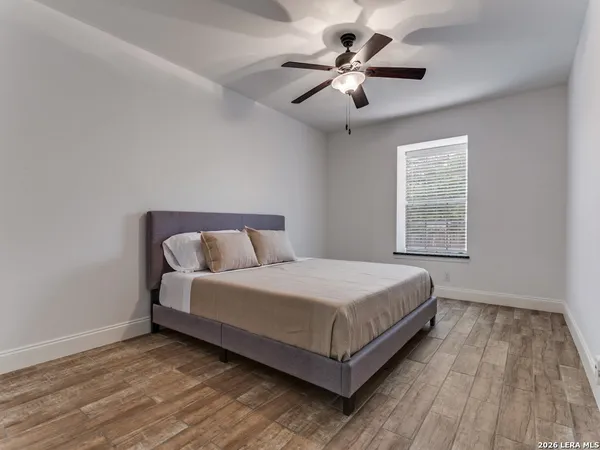 a bed sitting in a bedroom next to a window
