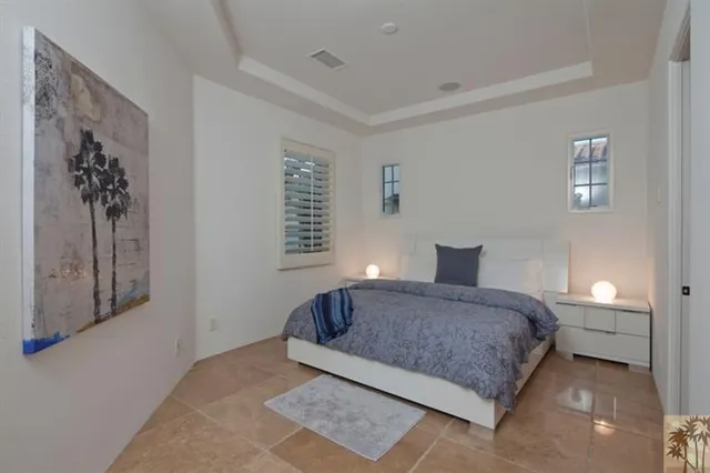 a living room with stainless steel appliances furniture a flat screen tv and kitchen view