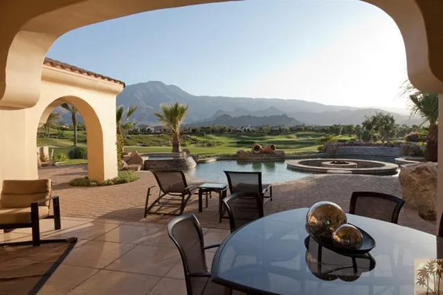 a view of a patio with a dining table and chairs