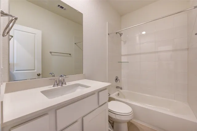 a bathroom with a sink toilet tub and shower