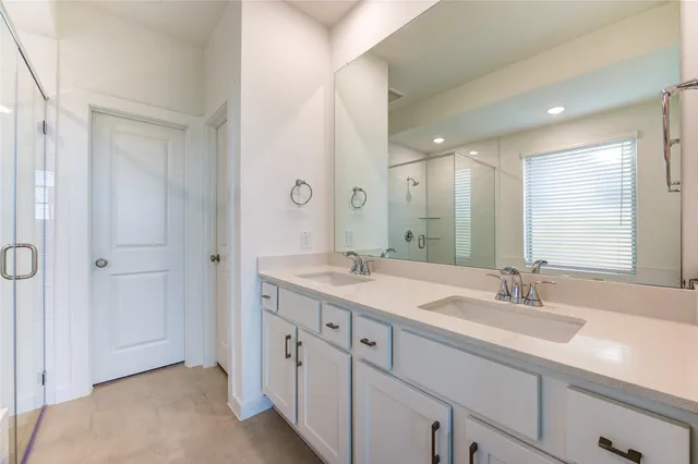 a bathroom with a granite countertop sink double and mirror
