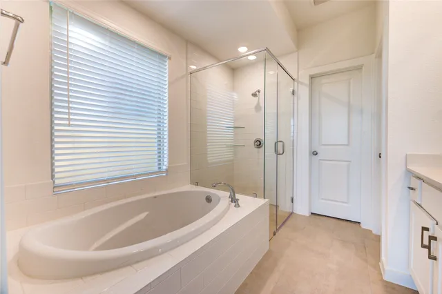 a white bath tub sitting next to a bathroom